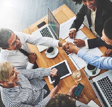 Group of business people sitting around table at a meeting.